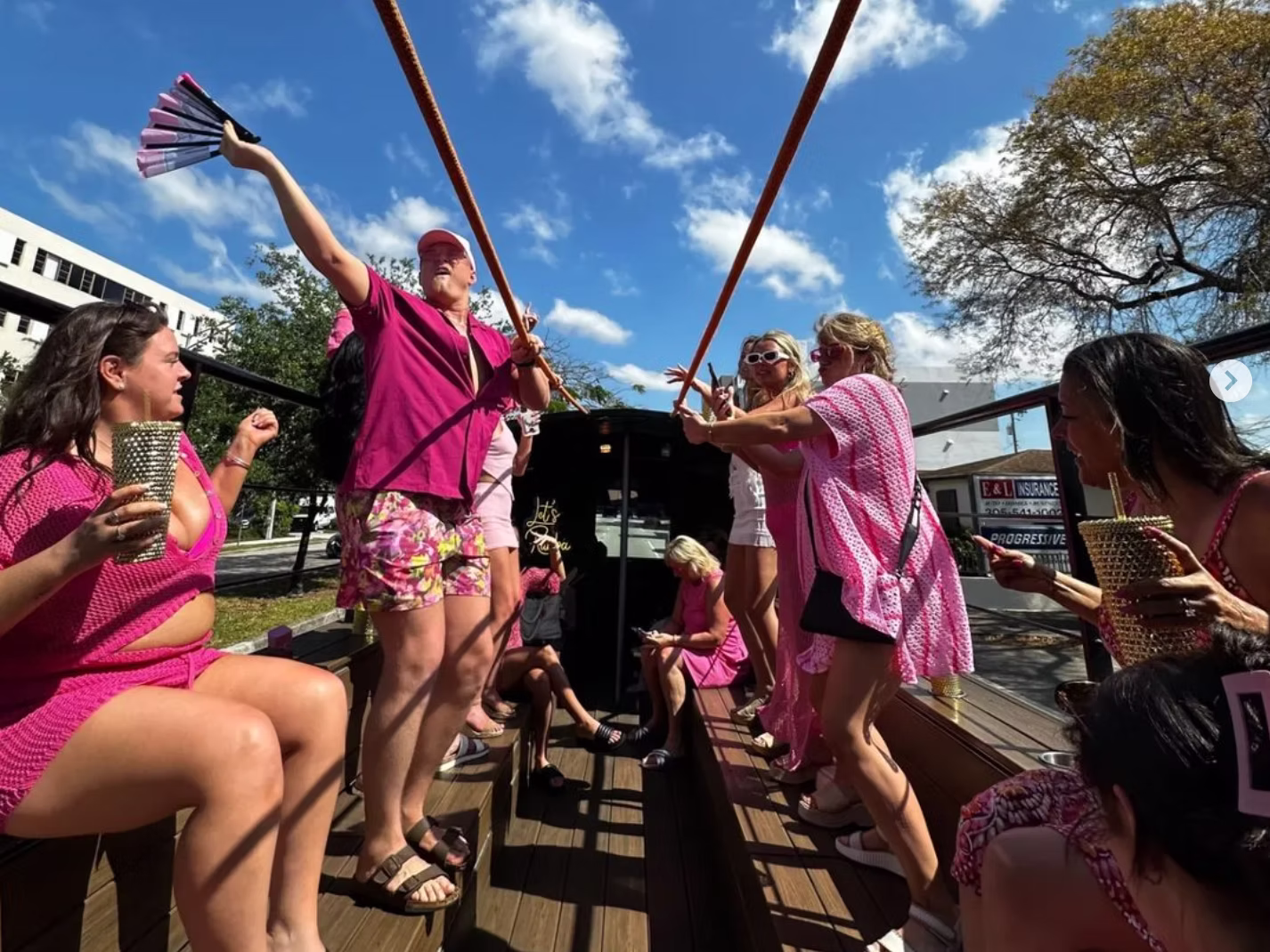 Group of bachelorette onboard an open air party bus in miami