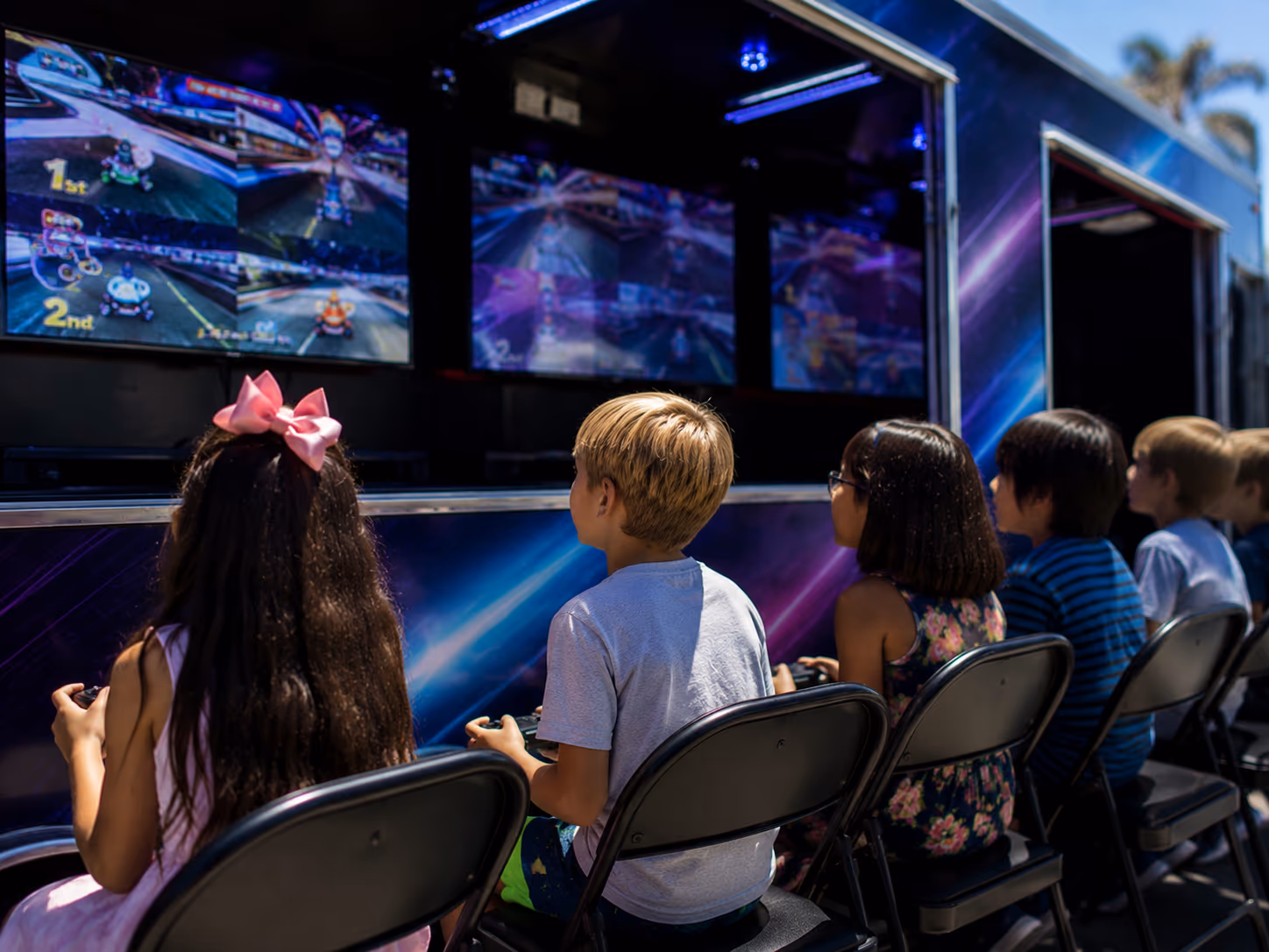 Outdoor gaming screens at a Miami game truck birthday party