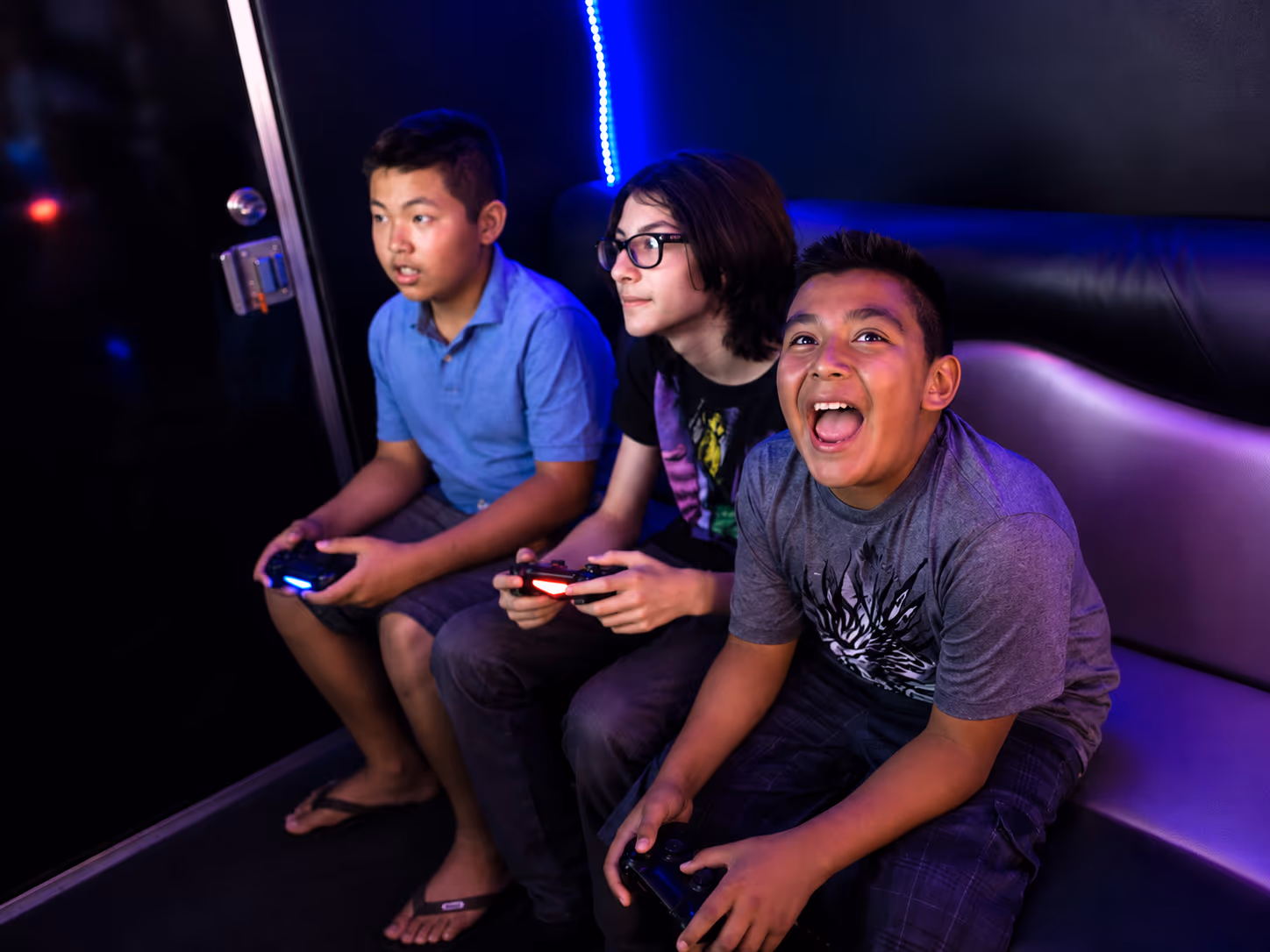 Kids laughing and gaming inside the Miami game truck