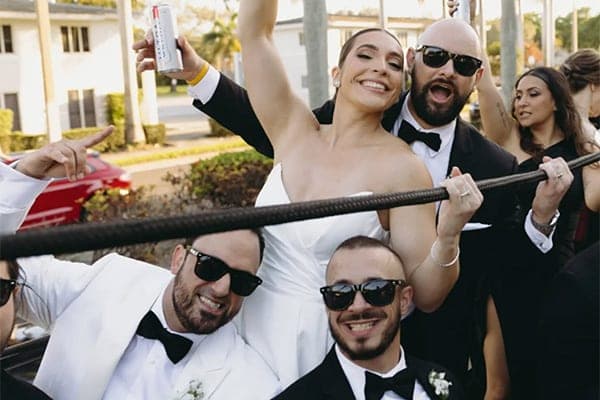 Happy bride and wedding party celebrating aboard a Rumbatours wedding ride in Miami
