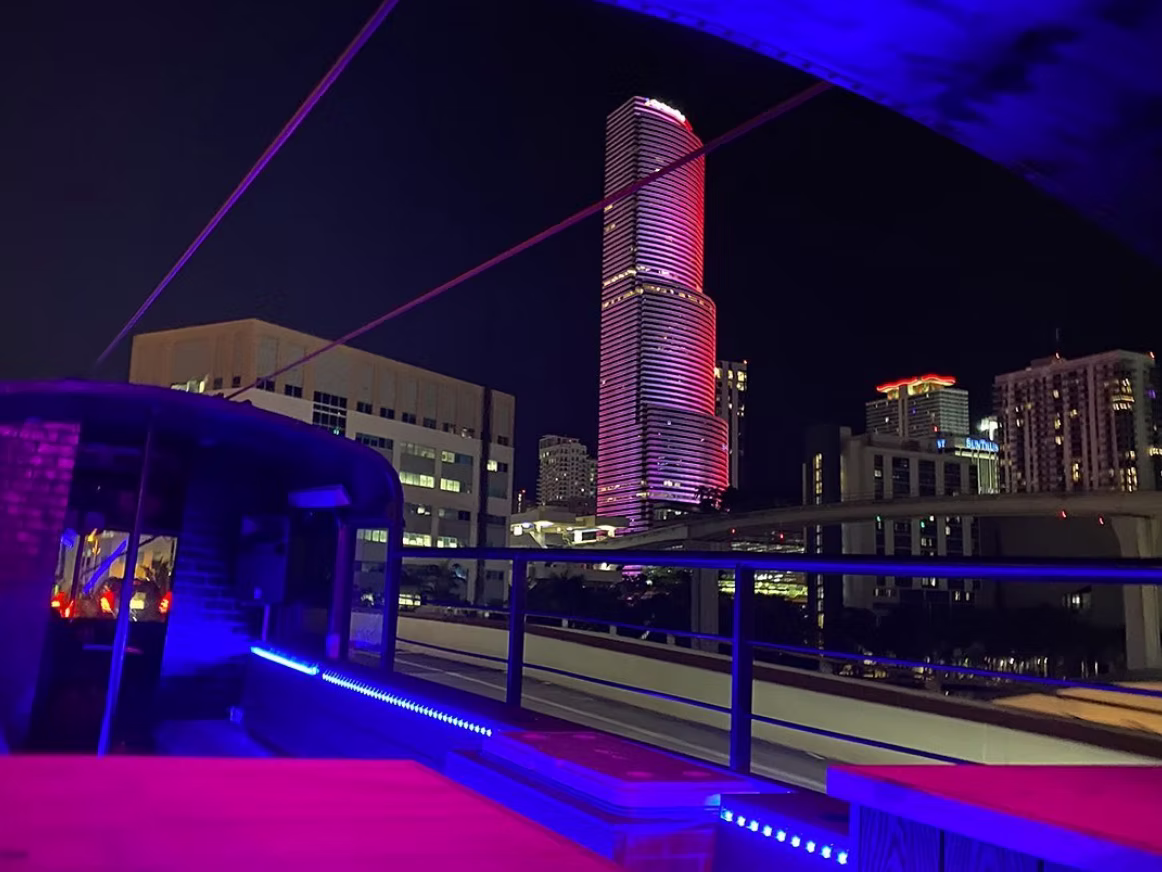 Friends enjoying a night out on an open-air party bus in Miami