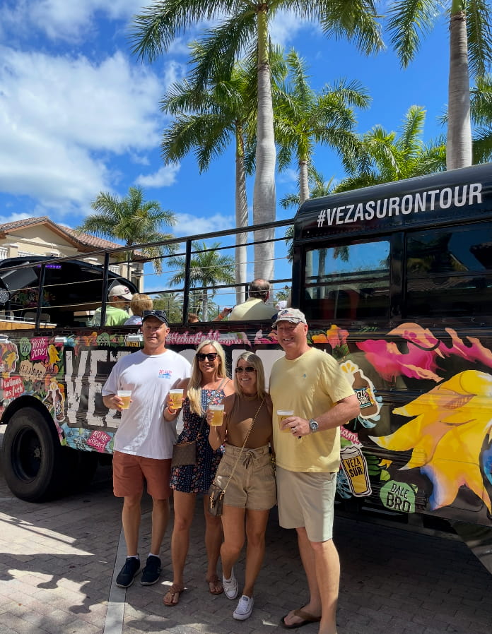 Group celebration next to open-air party bus